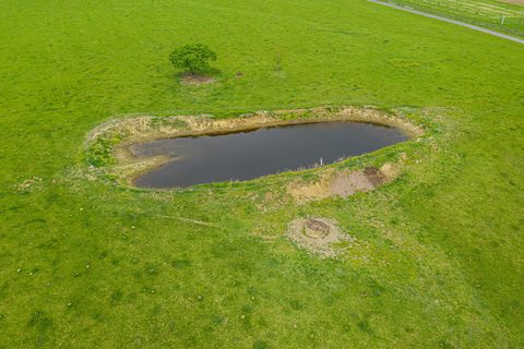 Aerial view of a farm pond set in open pasture near Elkwood, Culpeper County, Virginia