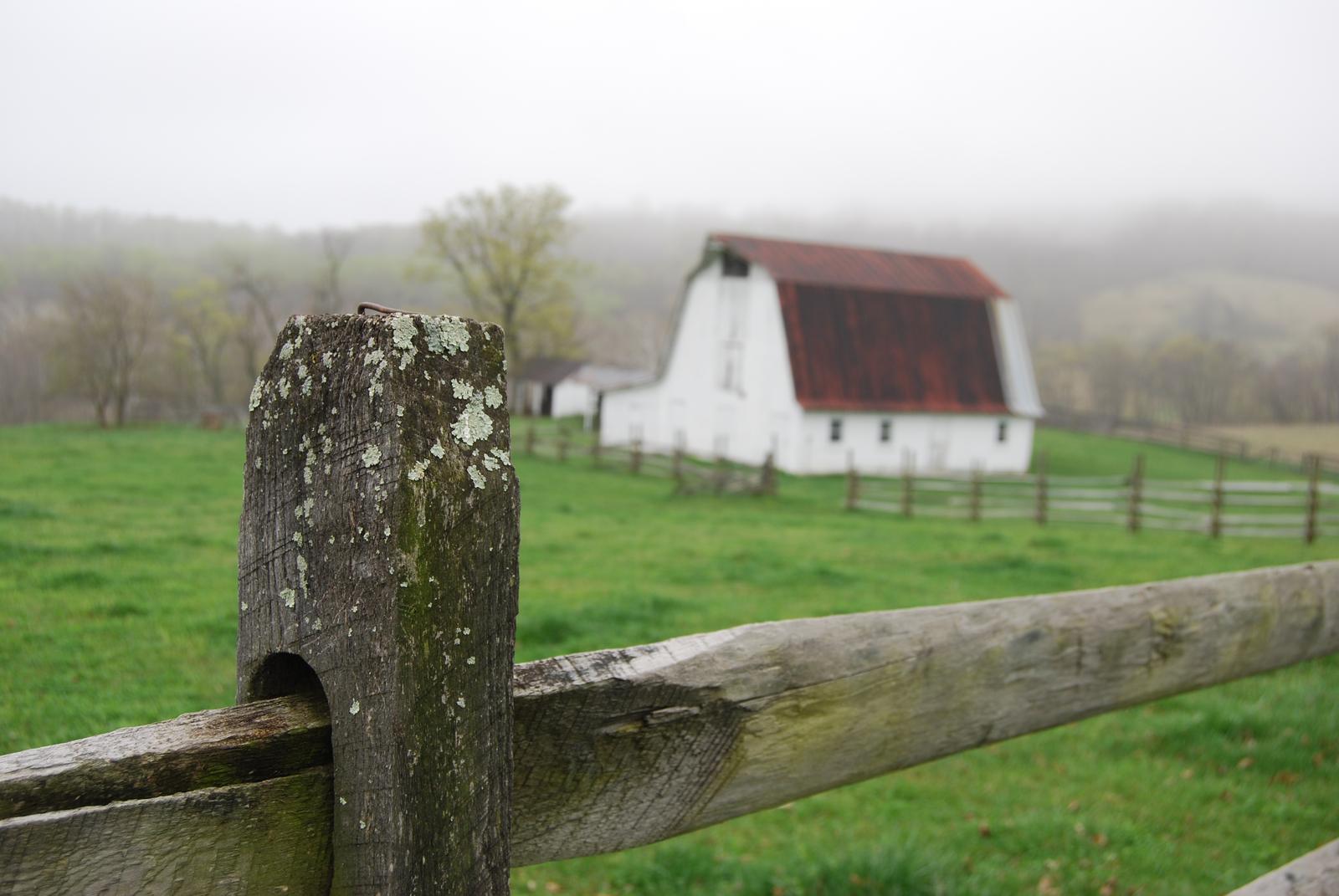 Old white barn and weathered fence post at Sky Meadows State Park, Fauquier County, Virginia
